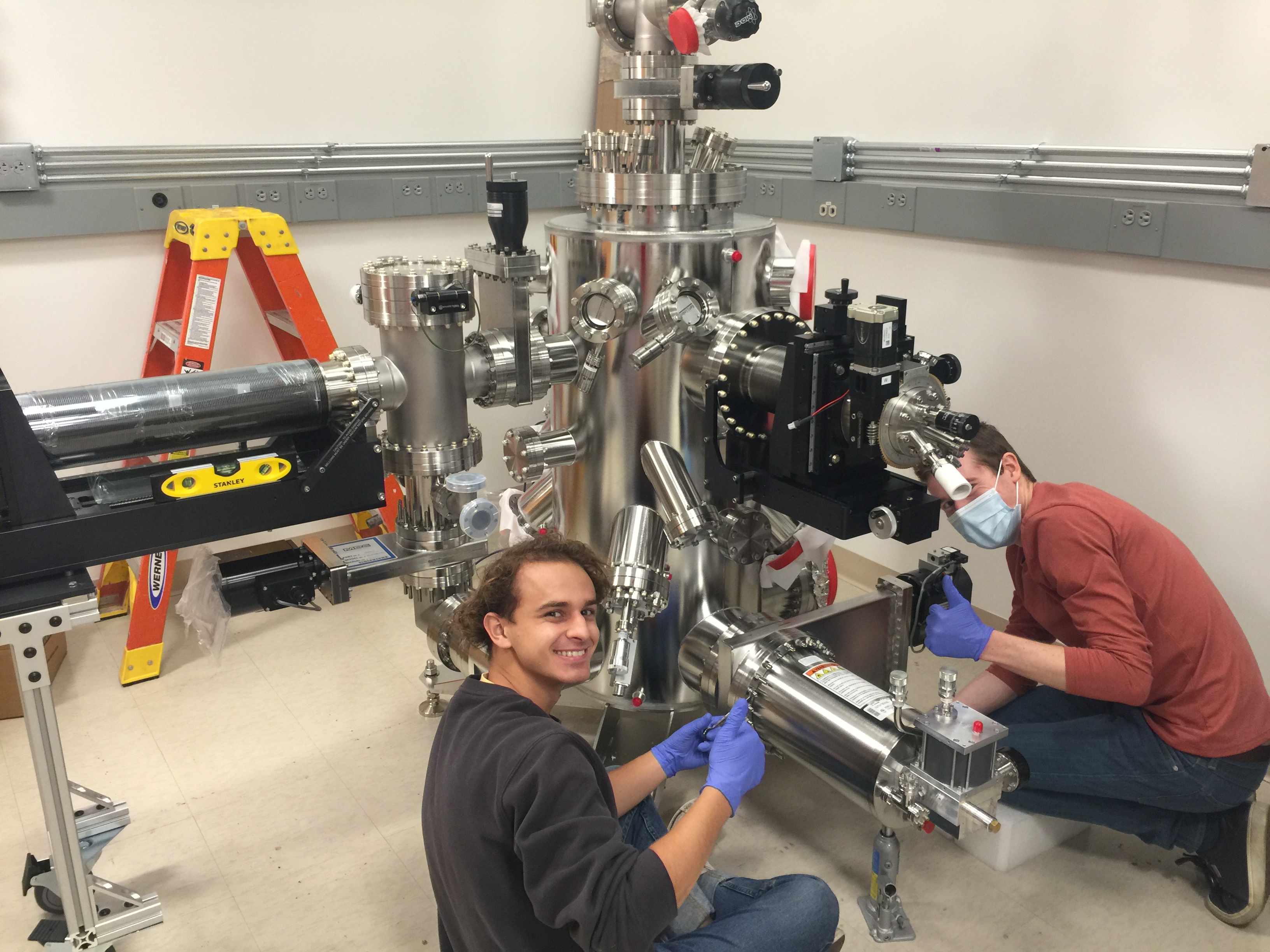 Linus (left) and Connor (right) work on adding components to the new vacuum chamber for the atomic imprint crystallization project